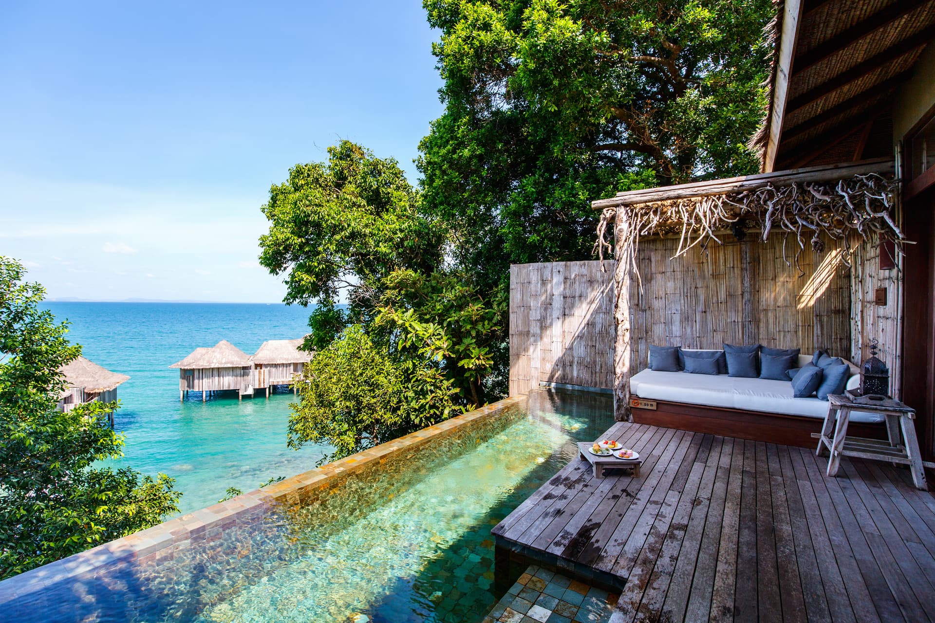 Overwater villa with infinity pool and turquoise sea
